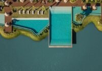Vista aérea da área de lazer do Condomínio Blue, com piscinas de água azul-turquesa, decks de madeira e espreguiçadeiras, ...